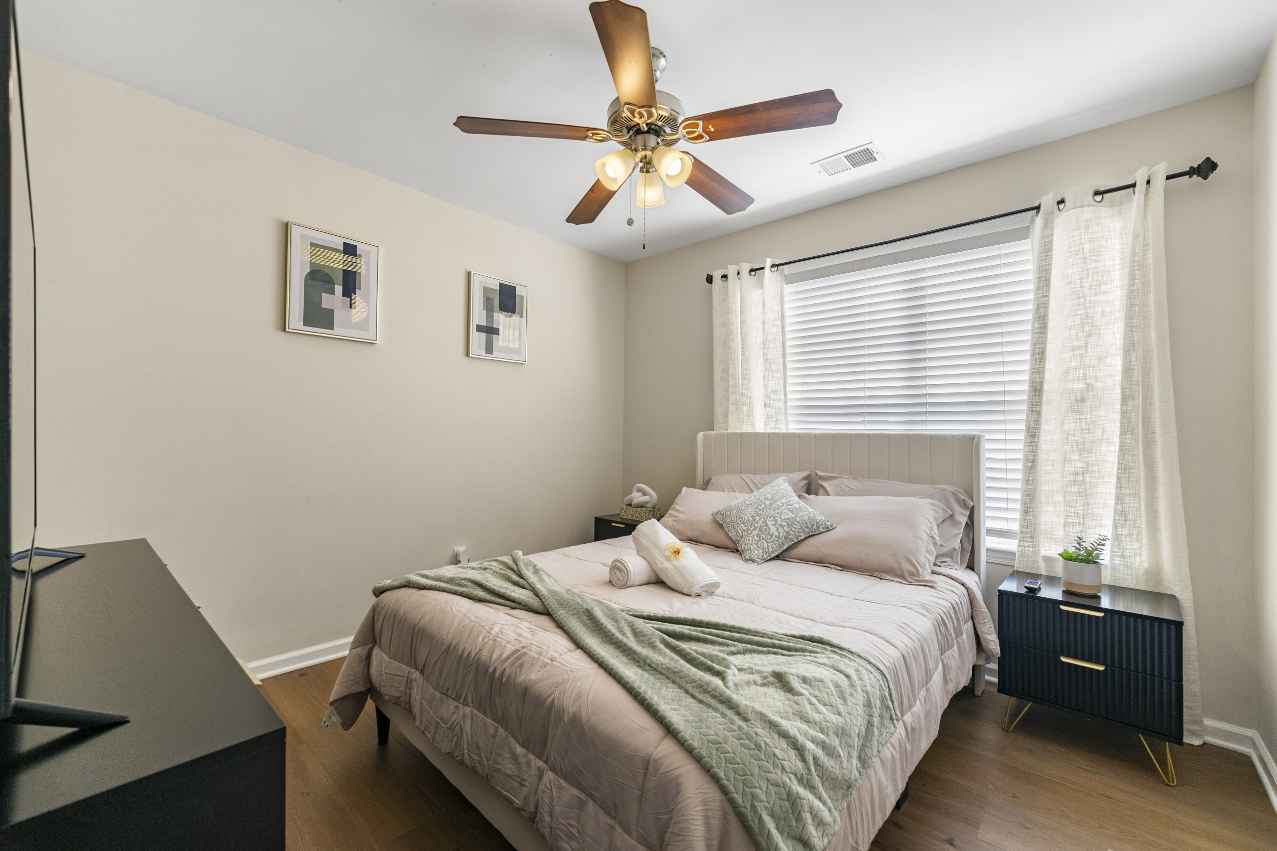 Clean queen bedroom in a worker-friendly furnished home