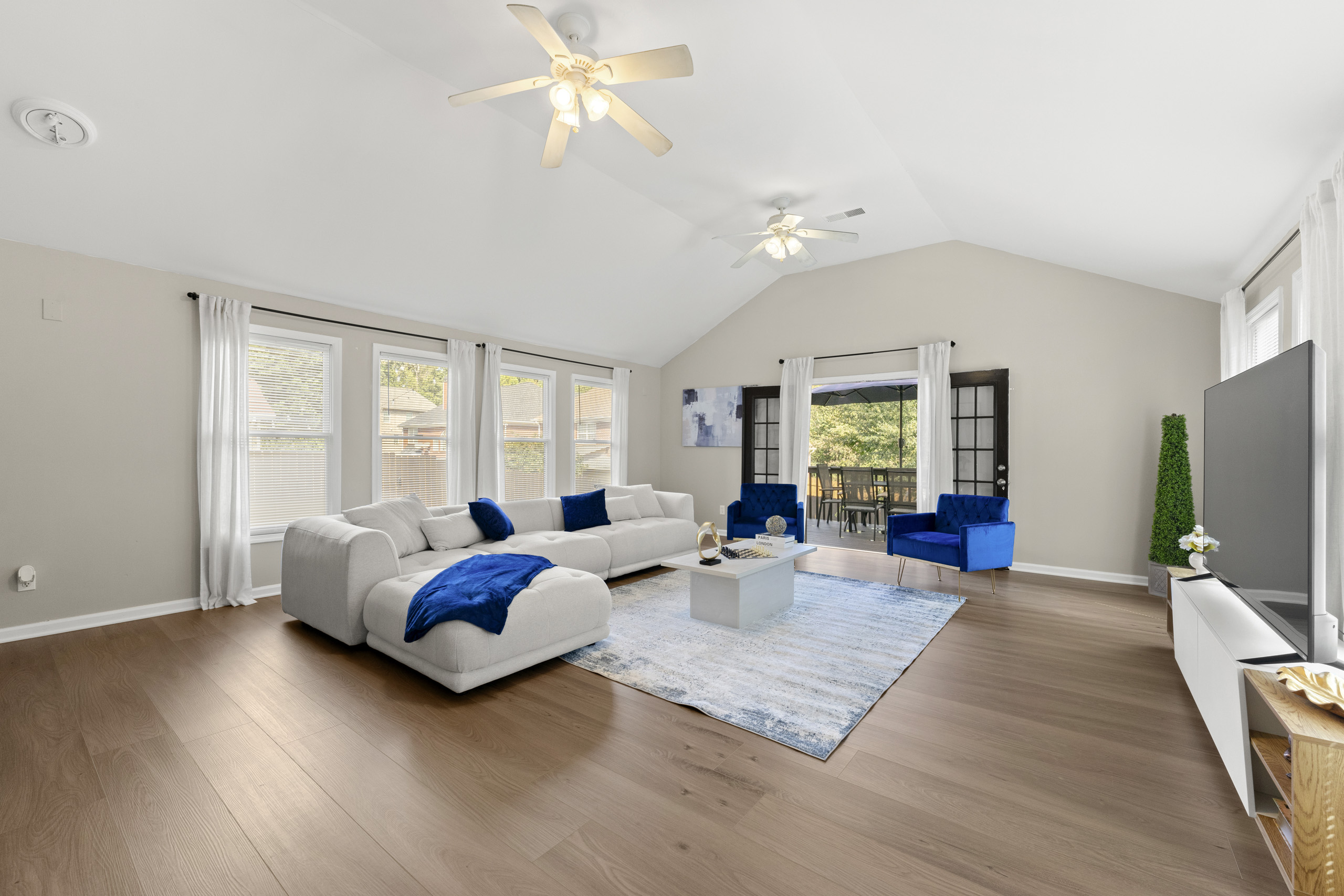 Shared living room with multiple seating areas in a furnished home